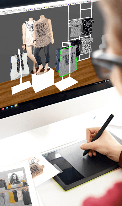 Photograph of a person mocking up a 3D store using LookDepot's Visual Merchandising Software